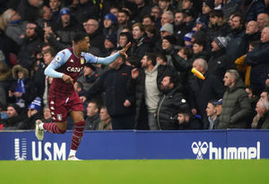 Aston Villa's Ezri Konsa throws a bottle to the touchline after it was thrown at celebrating Aston Villa players