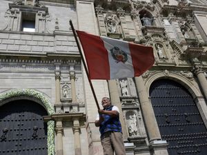 A man waving a Peruvian flag