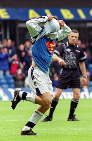 Albion's Enzo Maresca shows off his superman uniform after scoring Albion's first goal against Portsmouth at the Hawthorns.
