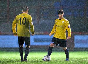 Charlie Barnett and Tony Gray of AFC Telford United prepare to kick off the second-half in torrential rain, mud and wind at Workington