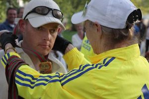 Michael receiving his medal for completing the London Marathon