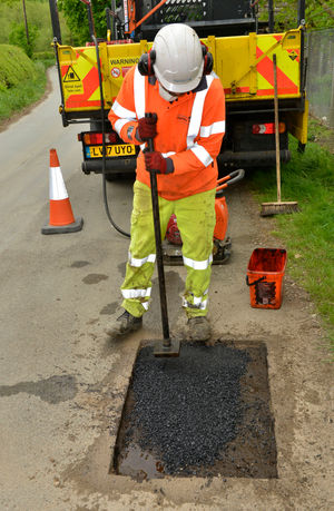 A pothole is levelled off ready for filling