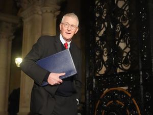 Hilary Benn carrying a blue folder under his right arm