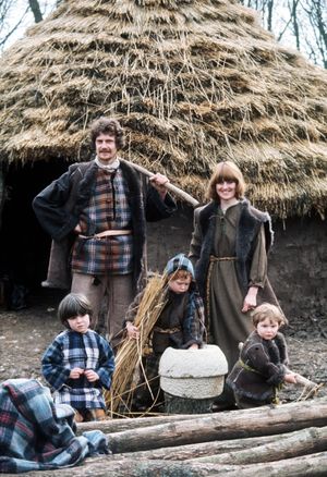 1977: Peter and Lindsay Ainsworth from Shropshire pose in front of a thatched roundhouse with their children (r-l) Robin (2), Nicholas (4) and Peter (6). They were part of a group of 15 volunteers who were to live the lives of Ancient Britons in a Celtic Iron Age settlement at a secret location near Shaftesbury, Dorset for a year.