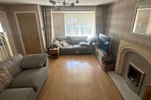 Spacious modern living area with feature wall and spot lighting