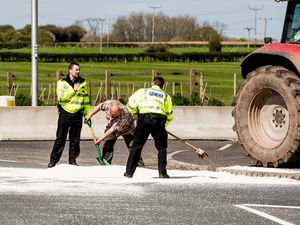 Supporting image for story: Pictures: Tractor spills fertiliser load at Oswestry roundabout