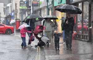 Visitors to the Bridgnorth Italian Moto Fest brave the horrendous downpours to view the cars on show