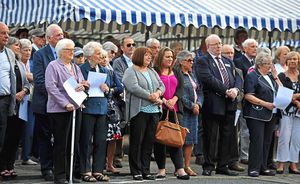 Crowds watch and listen respectfully at the ceremony