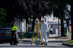 Police and forensics officers at the scene on College Road, Kingstanding, north of Birmingham, where a 14-year-old boy died after being stabbed on Monday evening. Police have launched a murder investigation and are hunting up to seven people in connection with the attack. Photo: Jacob King/PA Wire