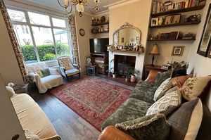 A large bay window fills the living room with light