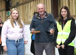 Corah and her grandfather Hayden Millward being presented with the award for the best modern tractor