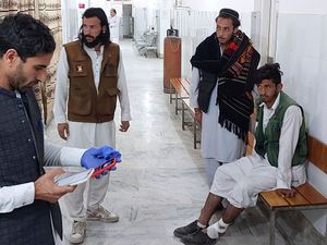 An injured victim awaits hospital treatment