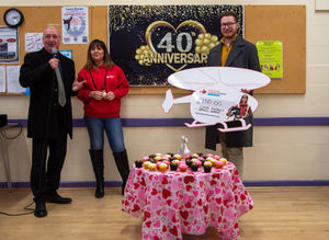 Councillor Steve Evans, left, and Councillor Chris Burden, right, join Kay Starkey from Midland Air Ambulance as the Long Knowle Tea Dance marked its 40th anniversary by donating £150 to the charity