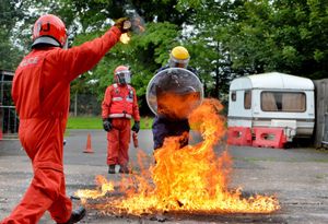 Reporter Juliet Hounam leaps through fire for petrol bomb training
