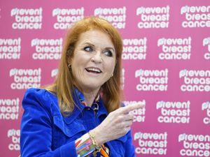 Sarah, Duchess of York in front of a pink 'Prevent Breast Cancer' background