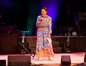 Birmingham 2022 Executive producer Raidene Carter shows off one of the costumes being worn during the festival