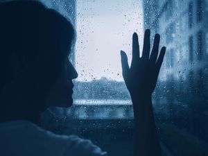 A woman touching a window