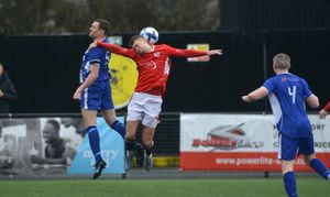 More action from Dudley as Matt Funge tries to win a header.