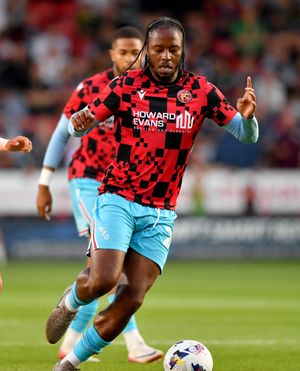 Romaine Sawyers warming up for Walsall at half-time.