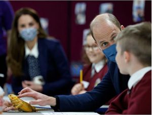The Duke of Cambridge strokes a chameleon alongside children from Loxdale Primary School during a visit to HugglePets in the Community