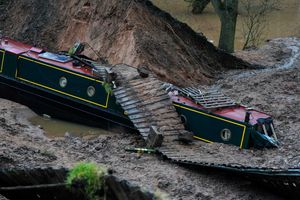 Two boats remain within a large "sinkhole". Photo: Jacob King/PA Wire 