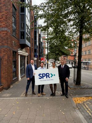SPR with sign outside new office on Newhall St, Birmingham. L to R - Jamie Naish, Alex Devlin, Jess Patel, Paul Cadman