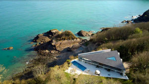 The corner of the house goes almost to the cliff edge