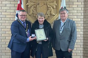 Mo Lloyd receiving her award from the Chairman of Powys County Council, Councillor William Powell with Councillor Gareth E Jones