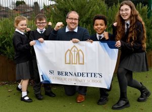 Headteacher Alex Turner, with pupils Frankie Duckhouse, aged 7, Marnie-Rose Morris, aged 7, Evie Jeremy, aged 10 and Marceau Ewunkem, aged 10 celebrate St Bernadette's Catholic Primary School, Brownhills receiving Outstanding for leadership.