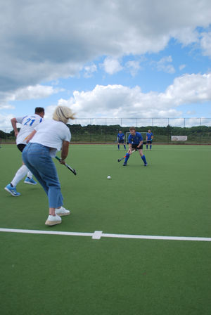 Alastair's widow Karen McIntyre starts the match, passing to her son Harry