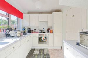 The kitchen has a large window overlooking the garden