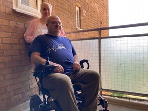 Richard England and his wife Gaynor on the balcony where he used to store his scooter until Dudley Council officers insisted he should keep it in his flat. Picture Martyn Smith/LDRS free for LDRS use