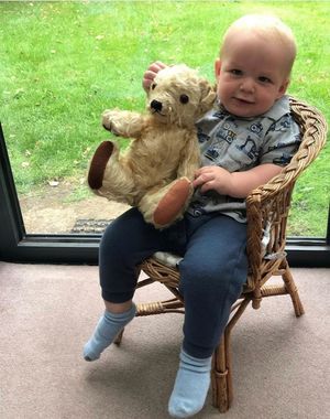 George Harwood in the same position as his grandfather, Alfred, with the same teddy bear - 86 years apart