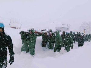 A rescue team in heavy snow