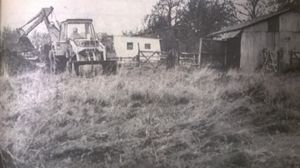 A digger prepares a grave for the slaughtered animals at Old Plough Farm at Bromstead, near Newport