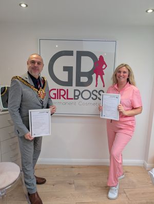 Laura & the mayor of Wolverhampton holding her compliance certificate from Wolverhampton council