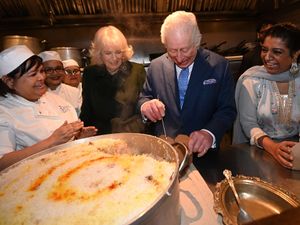 The King and Queen help pack donation boxes, with head chef Asha Pradhan and Darjeeling Express owner Asma Khan