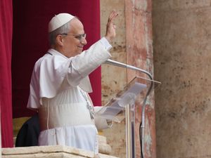 Pope Leo waving from a balcony