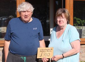John Bates presents Liz Lewis of the Rhayader Branch of Cancer Research UK their donation