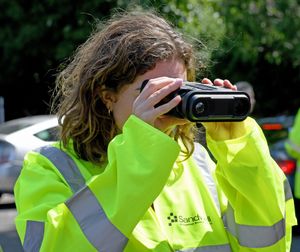 Sarah Coombes MP tries specialist goggles which police use to identify so-called 'ghost plates' during the operation in West Bromwich
