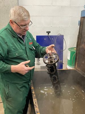 National Motor Museum Senior Engineer Ian Stanfield soaks camshaft glued by oil