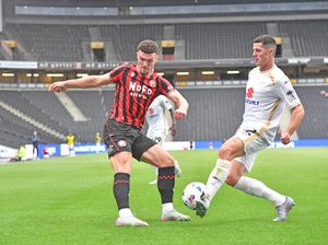 Jon Mellish blocks a cross from Walsall wing-back Connor Barrett.