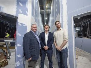 Councillor Stephen Simkins, James Jervis of PDJ, and Councillor Chris Burden stand between screens 1 and 2 of the new Lockworks Cinema