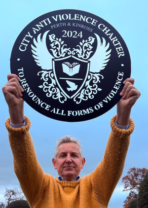 Clive Knowles – Holding Scotland’s Anti Violence Charter Plaque