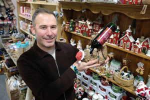 Daniel Bevis from Penelope Primrose holding a highland cow bottle holder. Daniel and his partner Laura Zissis have a shop in Builth Wells and sell gifts, socks, toys and homeware