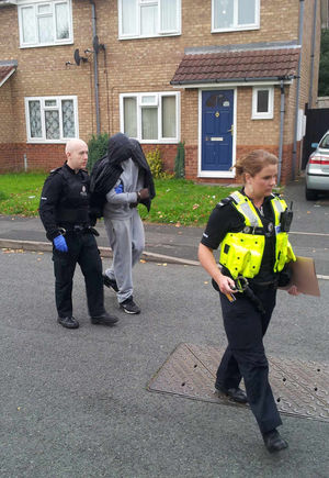 Shenrick Campbell covers his face as he is arrested