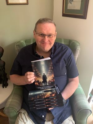 Andrew Detheridge with copies of his novel 'Where do we go from here?'
