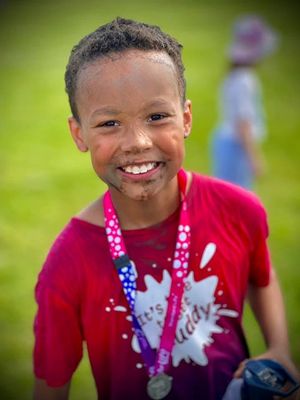 Kurtis after crossing the finishing line last year - his father Elan from Wolverhampton is now cancer free and is fronting the Race for Life campaign this year
