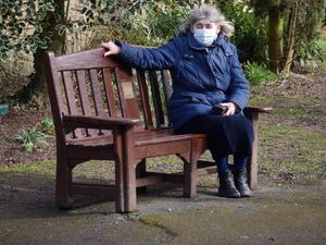 Jean Parker sat on one of the restored benches  