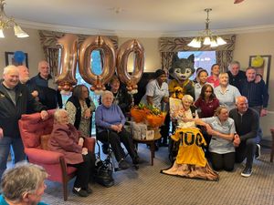 Joan with Steve Bull, Steve Daley, Phil Parkes, Joan's family, fellow residents, Wolfie the mascot and staff from Newcross Care Home